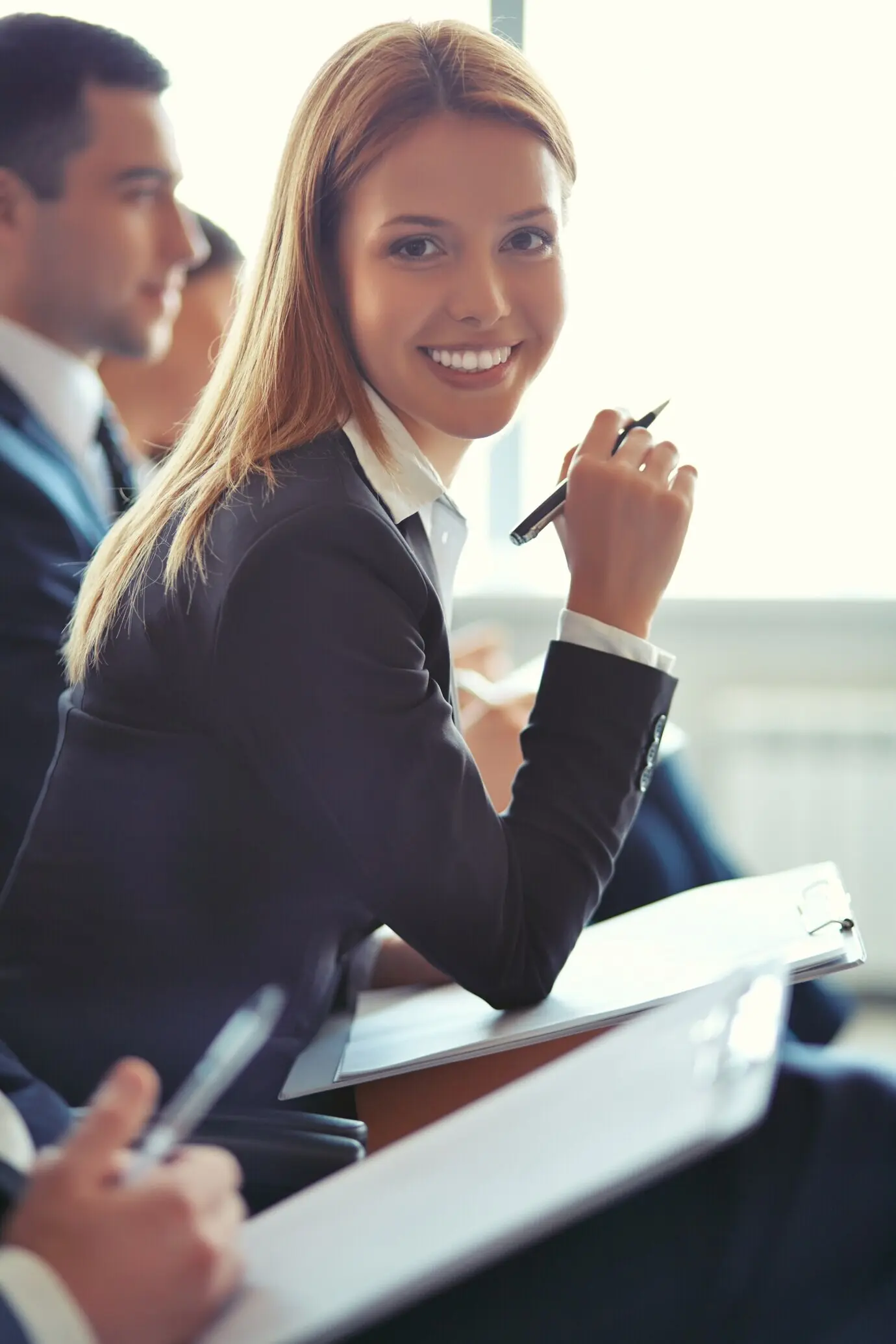 Blonde-haired executive with pen in her hand